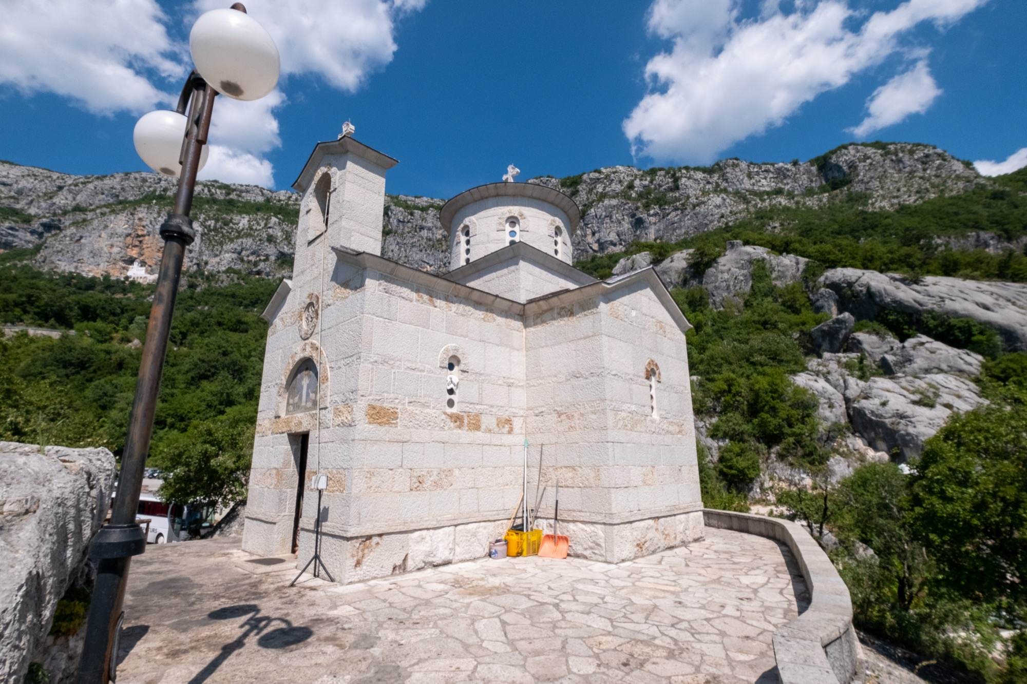 A stone church at the Lower Monastery of Ostrog under a blue sky